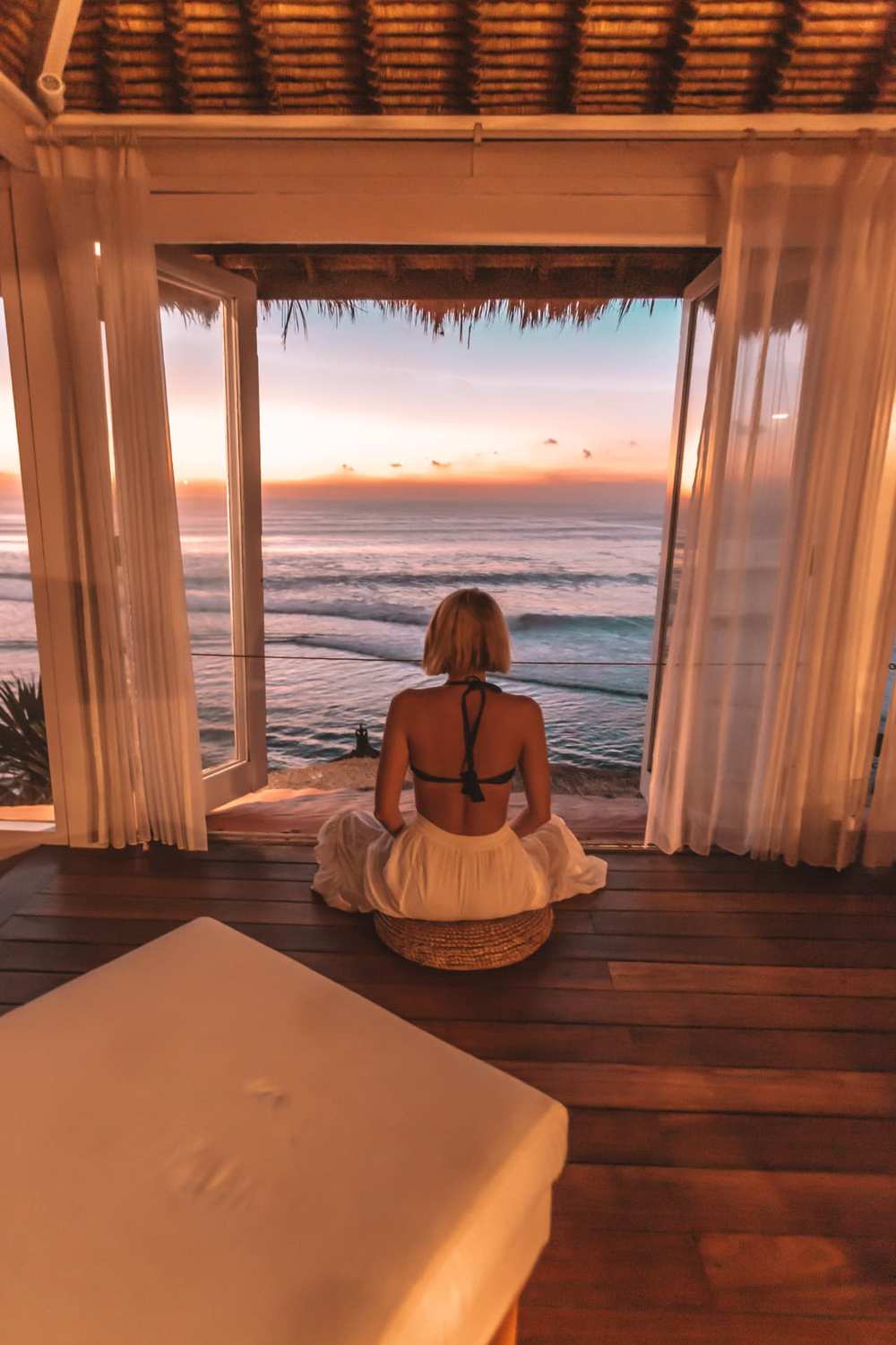 Meditation at sunset overlooking the ocean in Bali